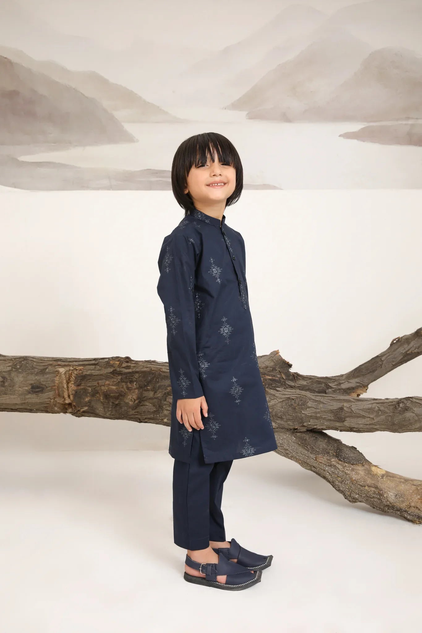 A child wearing a navy blue cotton embroidered kurta trouser
