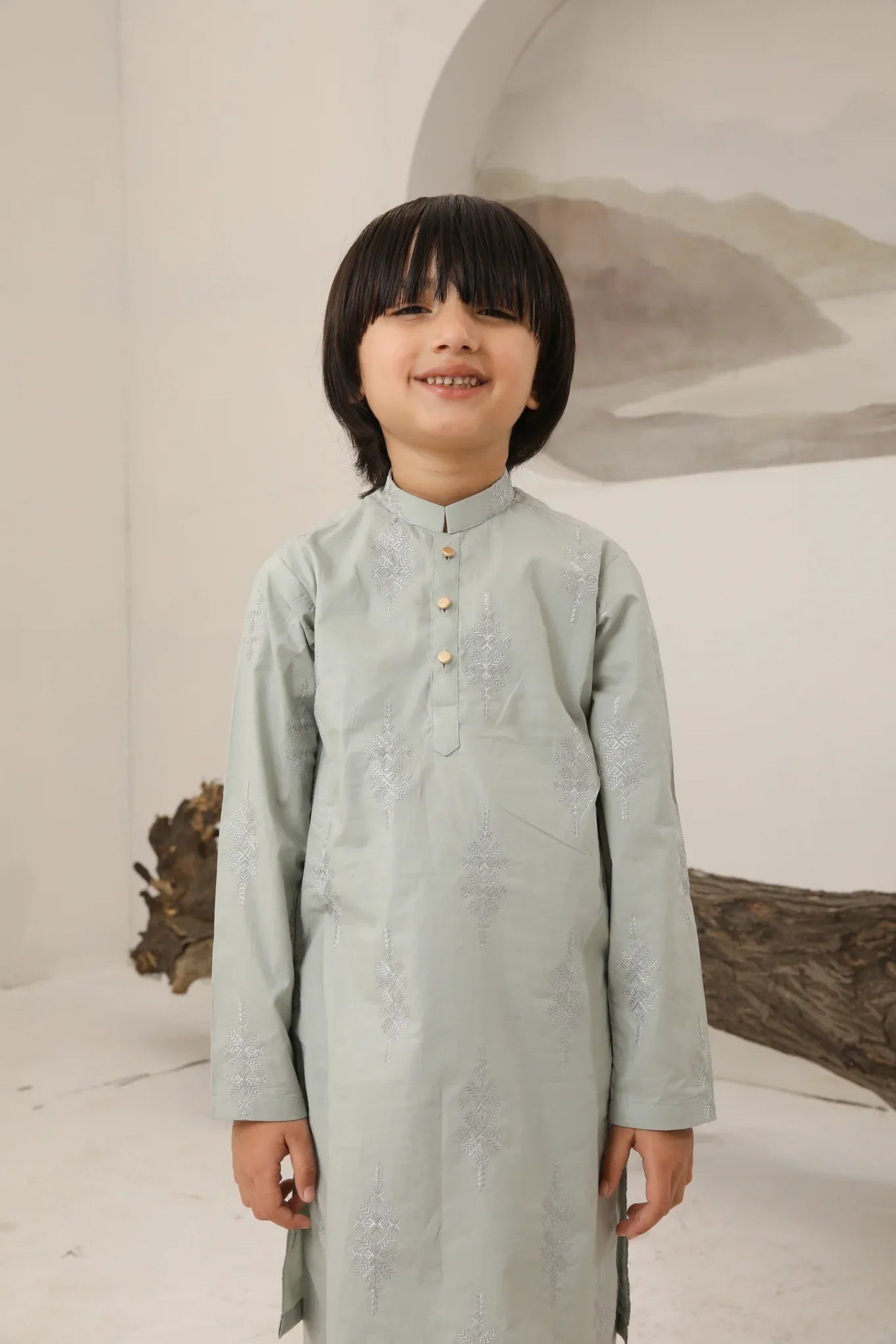 A child wearing a light mint soft cotton embroidered kurta trouser