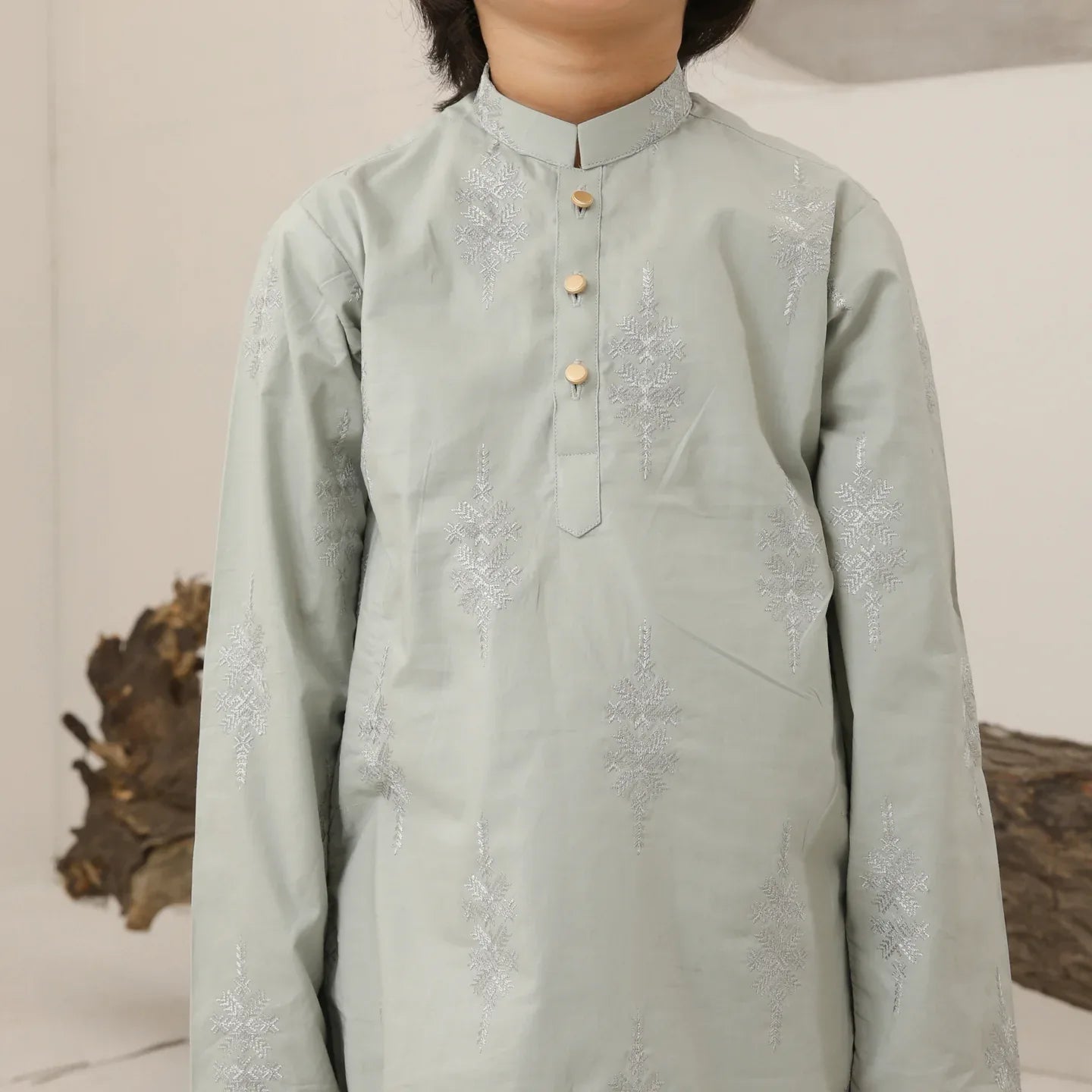 A child wearing a light mint soft cotton embroidered kurta trouser