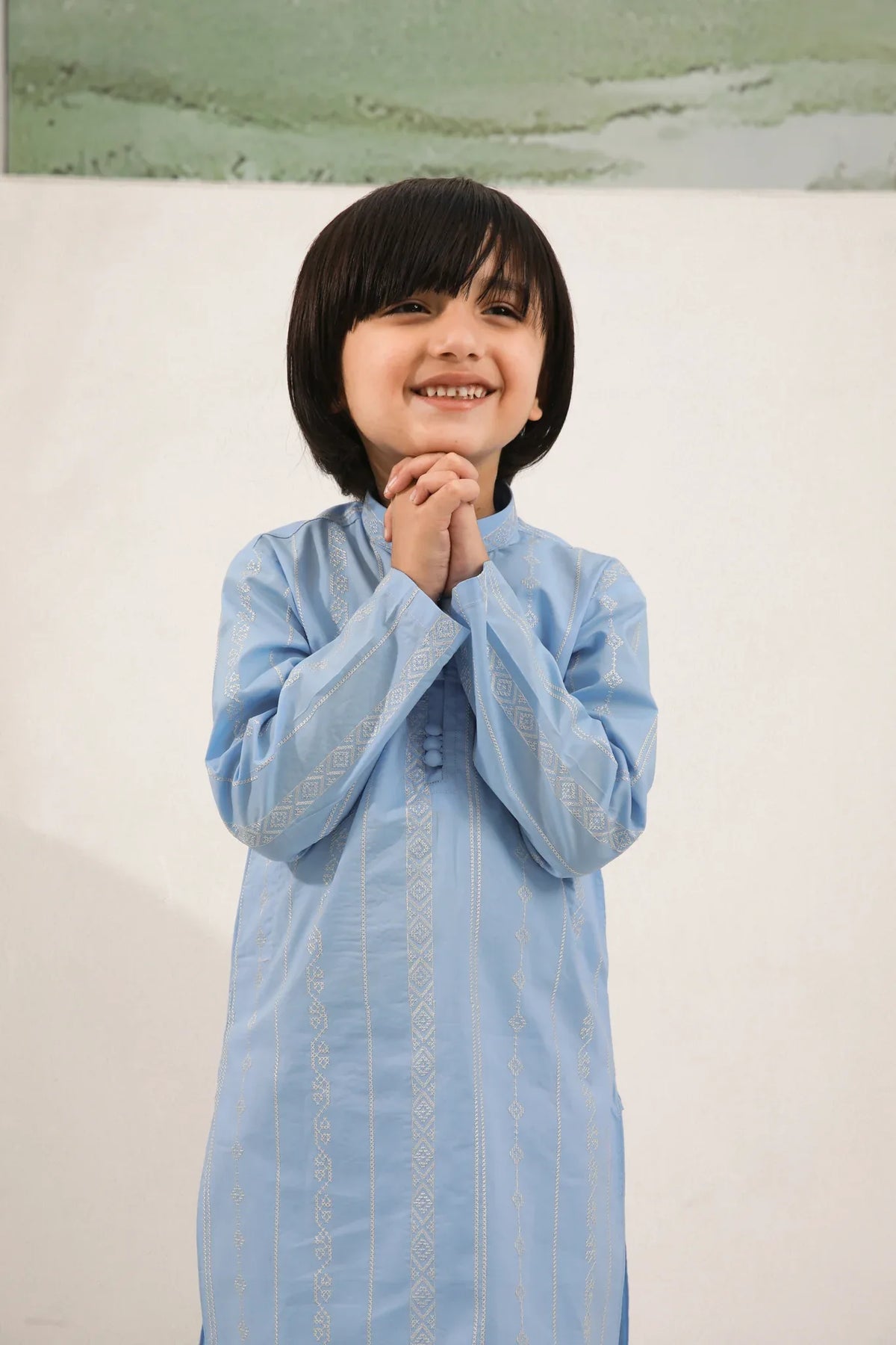 A child wearing a sky blue cotton embroidered kurta trouser